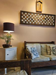 a living room with a couch and a table with a lamp at Casa Garay Hotel 658 in Asuncion