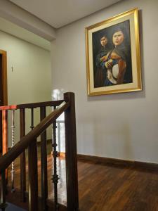 a painting hanging on a wall next to a staircase at Casa Garay Hotel 658 in Asuncion