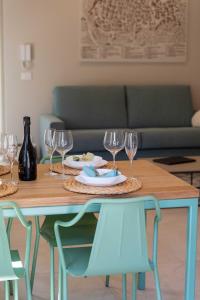 a table with glasses and plates of food on it at CENTRO STORICO - San Secondo Luxury Apartment in Asti