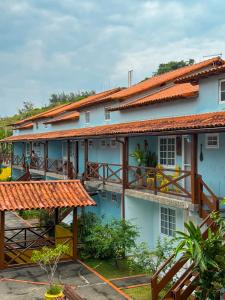 a building with orange roofs and balconies on it at Casa Azul Arraial in Arraial do Cabo