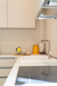 a kitchen counter with two cups and a sink at CENTRO STORICO - San Secondo Luxury Apartment in Asti