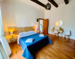 a bedroom with a blue bed and a wooden floor at Casa Blu Testaccio in Rome