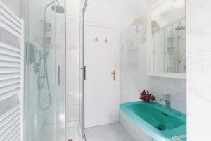 a bathroom with a blue sink and a shower at Piazza di Spagna Historic Flat in Rome