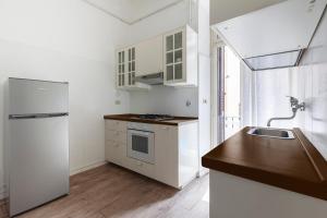 a kitchen with a white refrigerator and a sink at Piazza di Spagna Historic Flat in Rome +23 photos