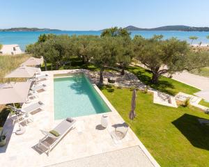 an aerial view of a swimming pool and the ocean at O`Life Boutique Apartments in Vodice