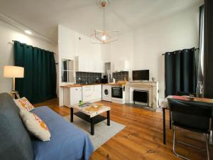 a living room with a couch and a table at Bel Appt-Quartier des halles-2 Pers-Animal accepté in Pau +23 photos