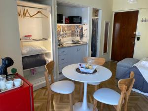 a small kitchen with a table and chairs in a room at Encantador estudio in Buenos Aires