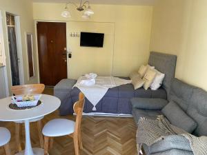 a living room with a bed and a couch at Encantador estudio in Buenos Aires