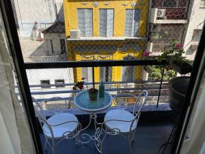 a view of a balcony with a table and chairs at Encantador estudio in Buenos Aires