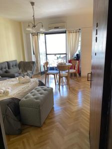 a living room with a bed and a table at Encantador estudio in Buenos Aires