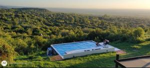 an overhead view of a swimming pool in a field at Mirador Merlo in Merlo