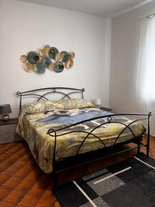 a bedroom with a bed with a metal frame at Casa Teresa in Murazzano
