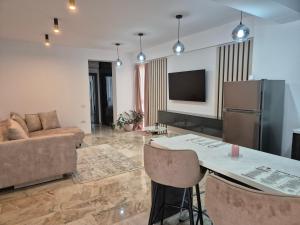 a living room with a couch and a table at Apartamente Vista Lago e Mare in Eforie Nord