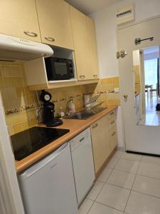 a kitchen with a sink and a stove top oven at Olivier in Le Lavandou
