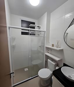 a bathroom with a shower and a toilet and a sink at (1506)Apt 2 Quartos Cabedelo- Ponta de Campina in Tambauzinho