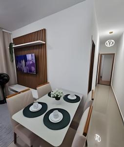 a dining room with a white table and chairs at (1506)Apt 2 Quartos Cabedelo- Ponta de Campina in Tambauzinho