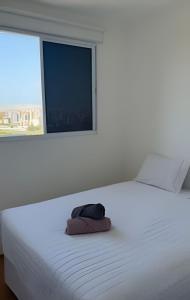 a bedroom with a white bed with a window at (1506)Apt 2 Quartos Cabedelo- Ponta de Campina in Tambauzinho