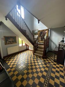 a staircase in a house with a checkered floor at Ruxley Rooms in Sidcup +34 photos