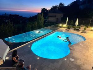 a woman in a swimming pool at night at BB Santalucia in Agerola