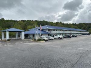 a large building with cars parked in a parking lot at Days Inn by Wyndham Renfro Valley Mount Vernon in Mount Vernon