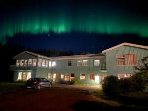 an apartment building with the aurora in the sky at Solheimar Eco-Village Guesthouse in Sólheimar
