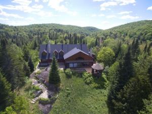 an aerial view of a large house in the woods at Howard Lodge & Spa in Saint Adolphe D'Howard
