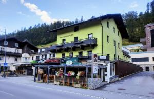 a yellow building on the side of a street at Apartments Hermann Arnold in Sölden
