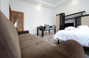 a bedroom with a couch and a bed and a table at "Deluxe Apartments" K 44 - 1225 in Lviv