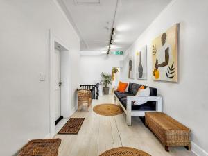 a living room with a couch and a table at Classy and Newly Renovated Studio in Observatory in Cape Town