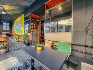 a table and chairs in front of a restaurant at Classy and Newly Renovated Studio in Observatory in Cape Town