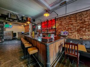 a bar in a restaurant with a brick wall at Classy and Newly Renovated Studio in Observatory in Cape Town