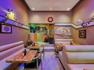 a restaurant with tables and couches in a room at Classy and Newly Renovated Studio in Observatory in Cape Town