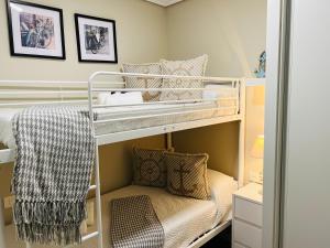 a bedroom with two bunk beds with a couch at RioMar in Redondela