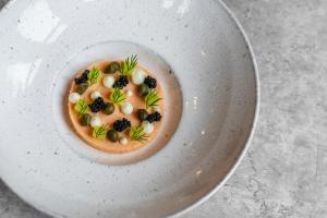 a bowl of food on a white plate at Bunchrew House Hotel in Inverness