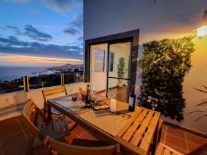 a dining room with a table and a view of the ocean at Funchal Sunset Apartment in Funchal