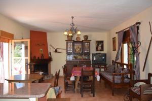 a living room with a table and a dining room at caballero y cozar 2 in Siles
