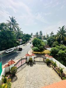 a view of a street with a fence and a road at Cleety's Residency in Cochin