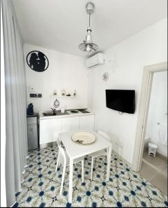 a white table and chair in a white room at Vento del Mar Tramontana in San Cataldo