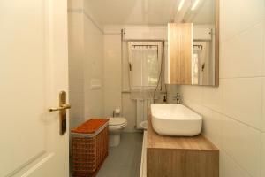 a bathroom with a sink and a toilet and a mirror at Elegante SUiTE a 5 min da Centro STORiCO di PERUGiA in Perugia +17 photos