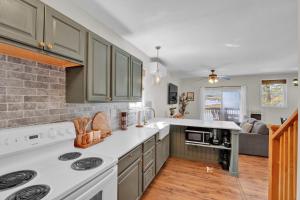 a kitchen with green cabinets and white counter tops at Lakefront Lodge, Hot Tub, Dock, Kayaks in Lake Ariel