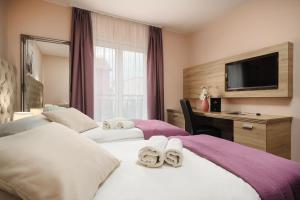 a hotel room with two beds and a television at Hotel Stella Maris - Style & Comfort in Vodice +66 photos
