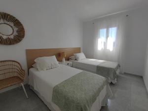 a hotel room with two beds and a mirror at Bungalow next Yumbo Center in Playa del Ingles +23 photos