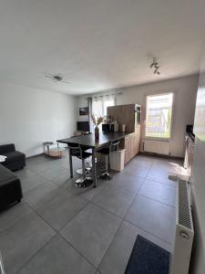 a living room with a table and a kitchen at Vue lac - T2 rénové - Parking - 4 pers in Gap
