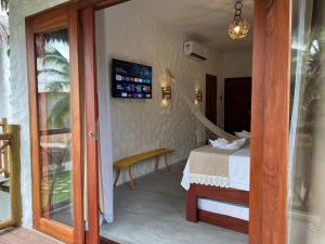 a hotel room with a bed and a sliding glass door at Casa di Maria flats in Icaraí