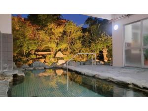 a swimming pool in the middle of a house at Hill Hotel Sunpia Iga - Vacation STAY 92293v in Iga