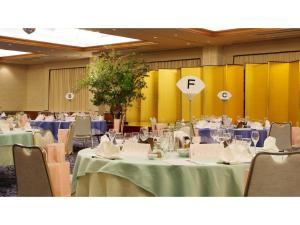 a conference room with tables and chairs and a yellow wall at Hill Hotel Sunpia Iga - Vacation STAY 92288v in Iga +75 photos