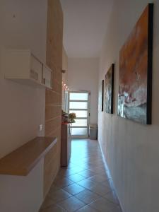 a hallway of a kitchen with a tile floor at ARZERIA in Cavallino di Lecce