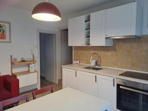 a kitchen with white cabinets and a table and chairs at Casa Vanna in Mezzano