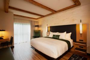 a bedroom with a large bed and a desk at The Swiftwater in Swiftwater