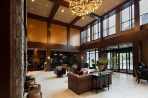 a large lobby with couches and chairs and a chandelier at The Swiftwater in Swiftwater